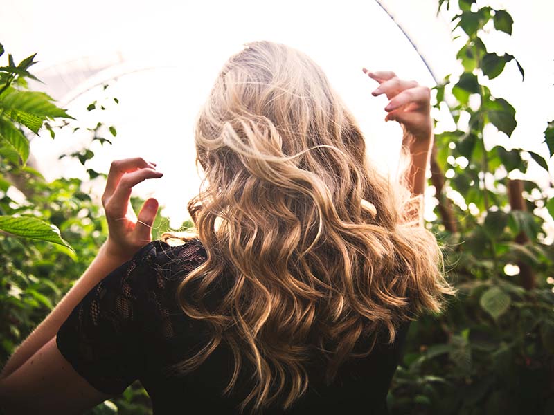 woman with lush blonde curled hair